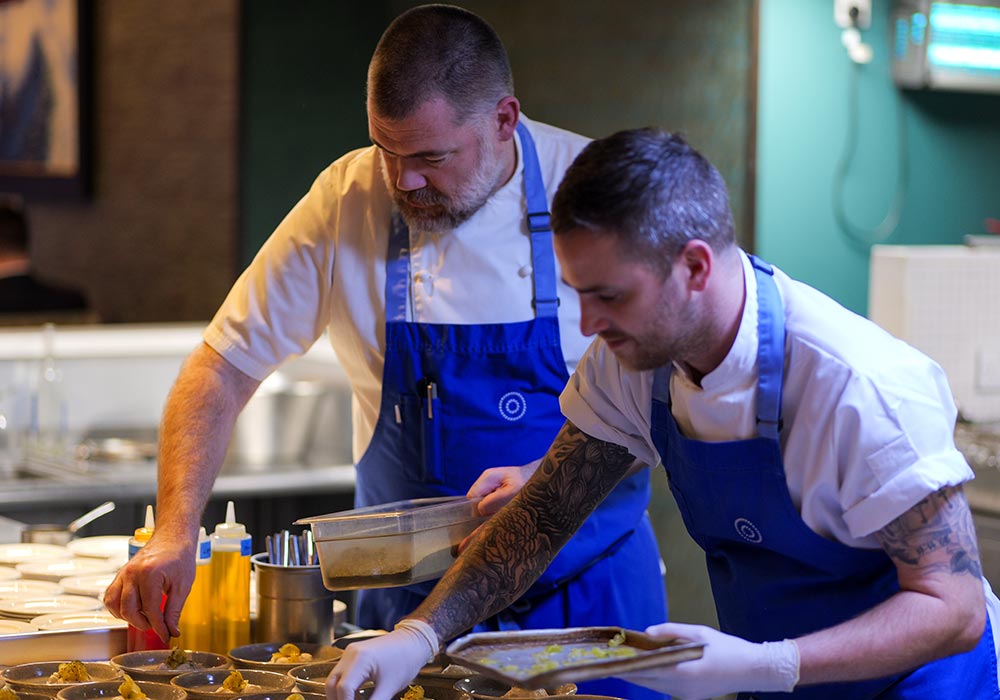 An Image of Nathan Outlaw prepping at Signature Food Festival 2024