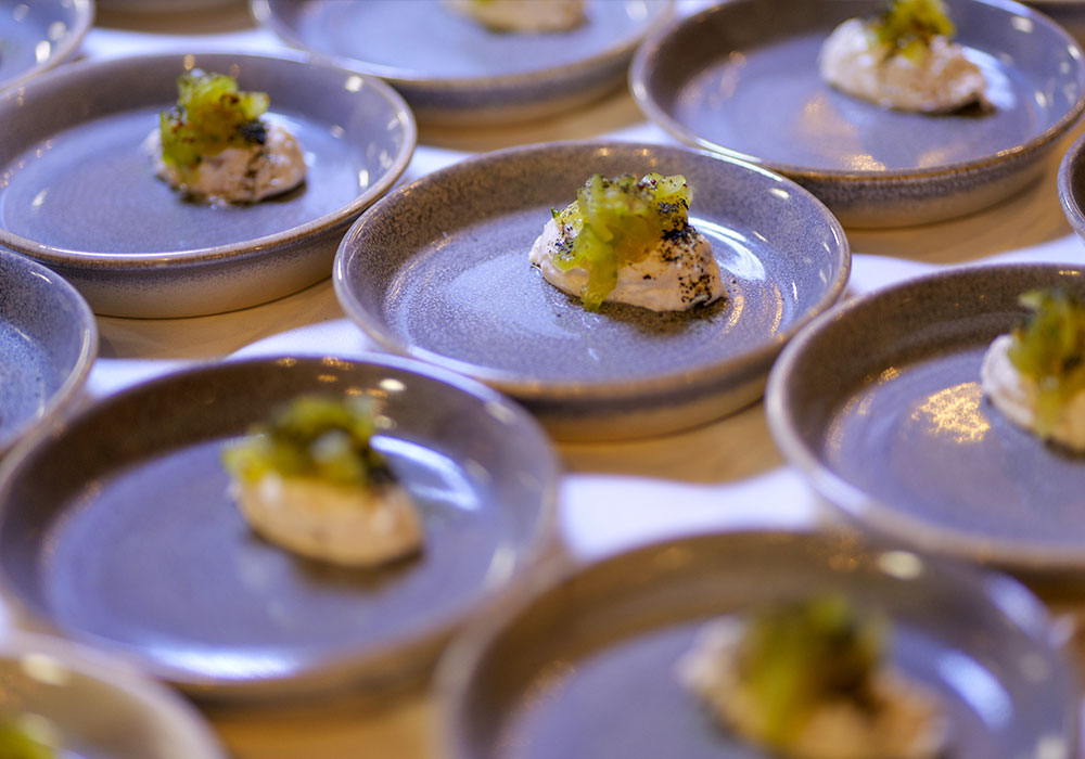 An Image of Nathan Outlaw's food prep at Signature Food Festival 2024
