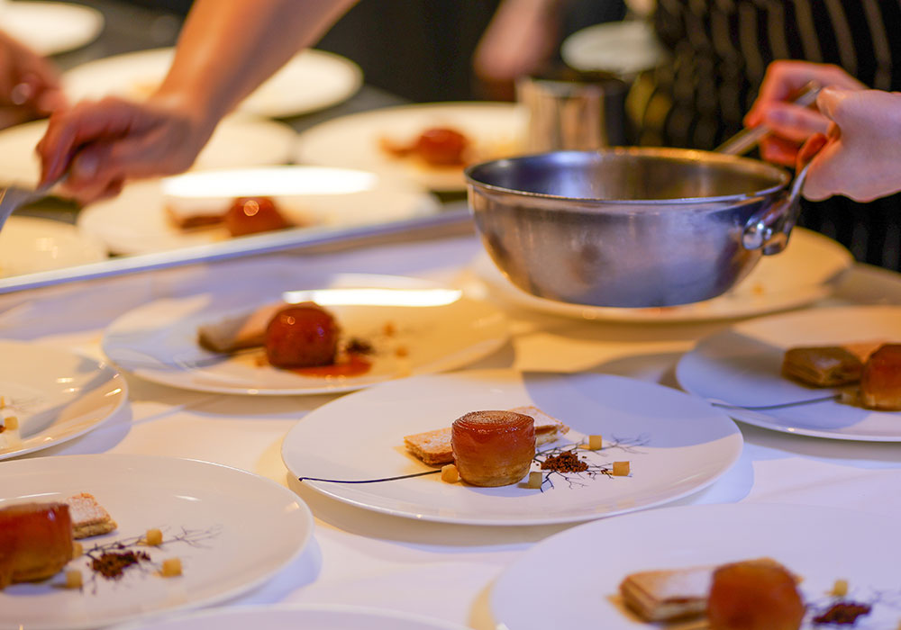 An Image of Michel Roux Jr prepping at Signature Food Festival 2024