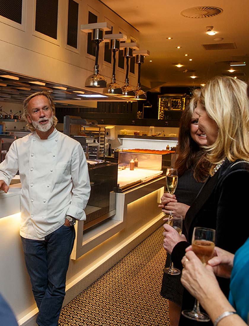 An Image of Chef Marcus Wareing chatting to sponsors at Signature Food Festival
